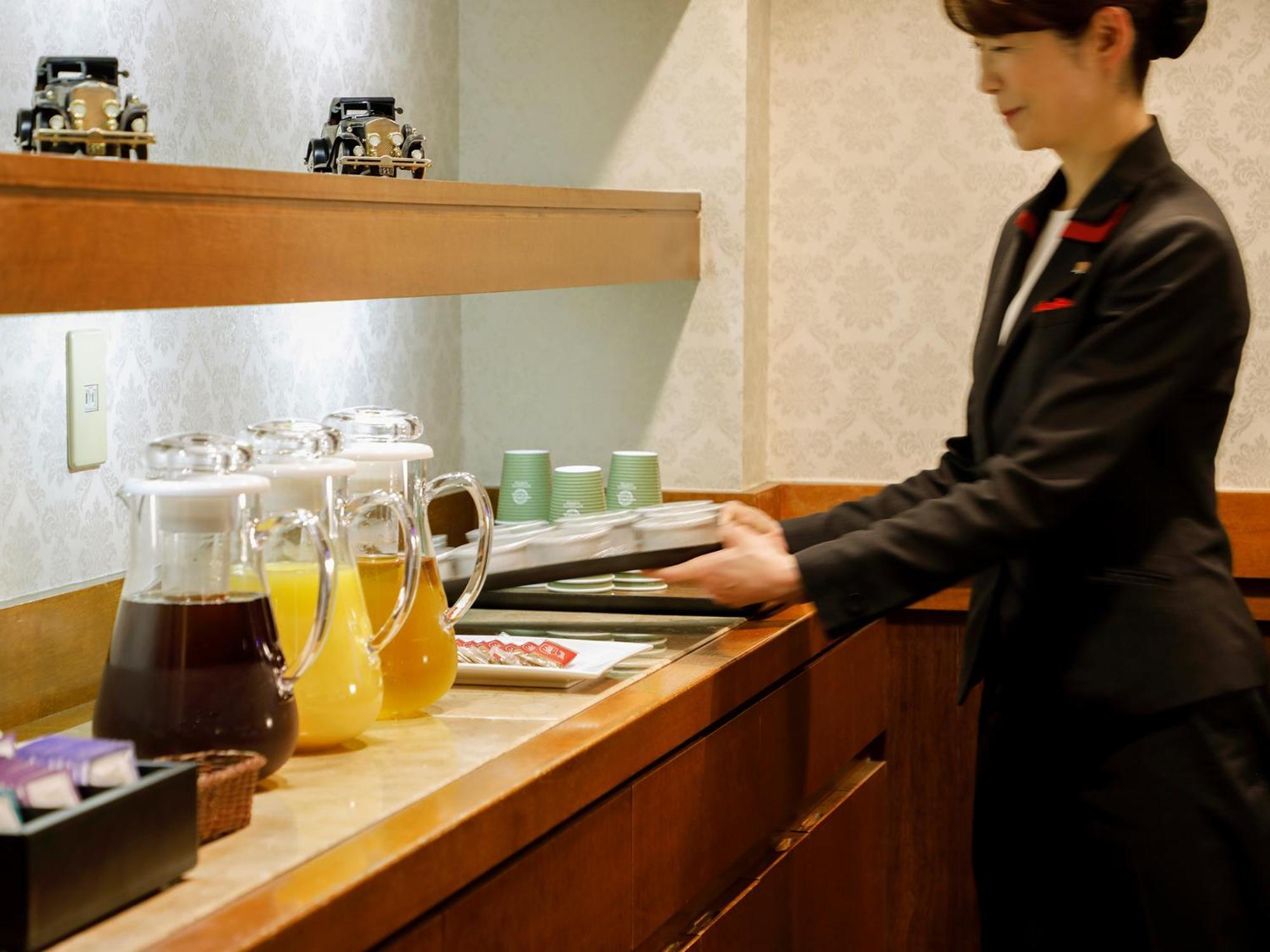 Premier Hotel -Tsubaki- Сапоро Екстериор снимка A flight attendant working on board a plane